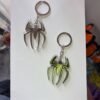 Spider-Man logo emblem keychain golden and silver metal Marvel accessory kaizoq anime merc kaizoku realm anime store uganda